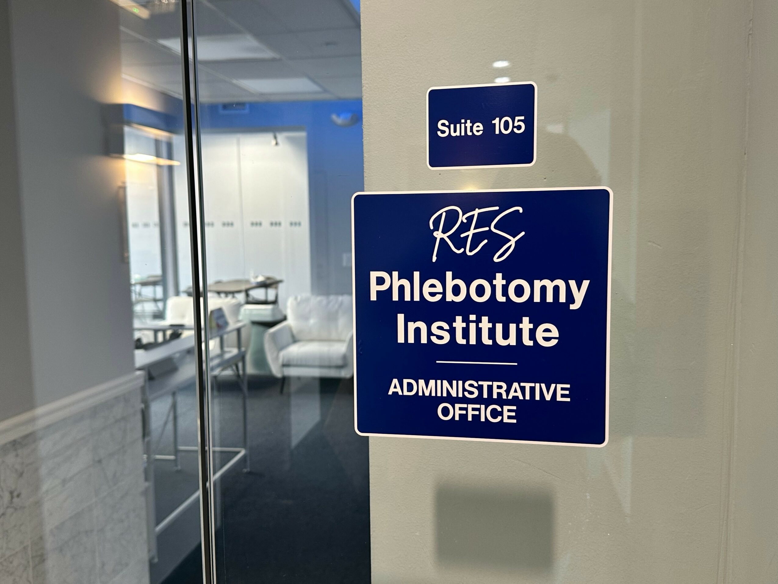 Blue sign indicating Suite 105 for RES Phlebotomy Institute Administrative Office.