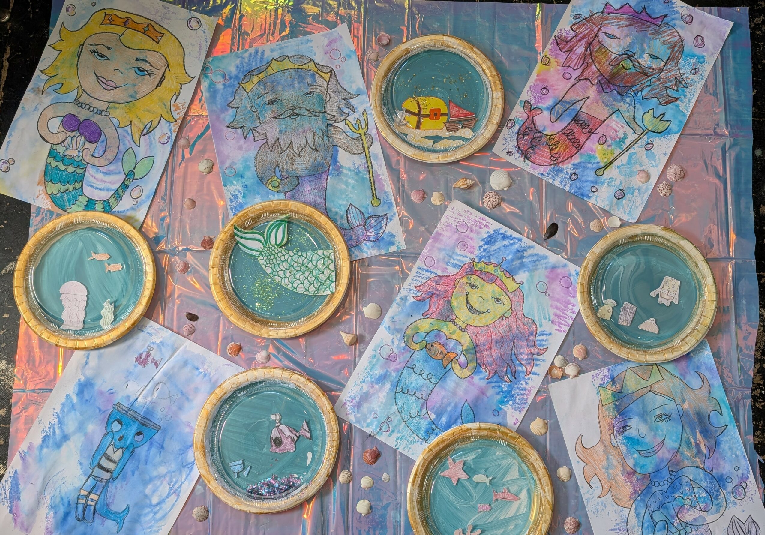 Colorful children's drawings of characters and animals, with some circular game pieces on a pink surface.