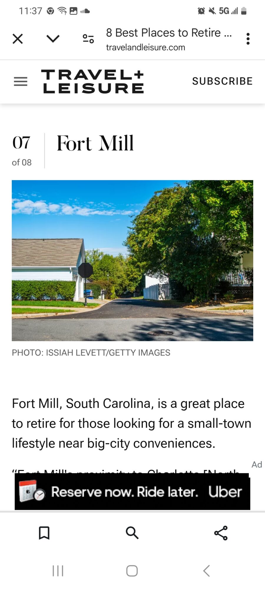 Street view with trees, a building, and a clear blue sky, promoting Fort Mill, South Carolina, as a retirement destination.
