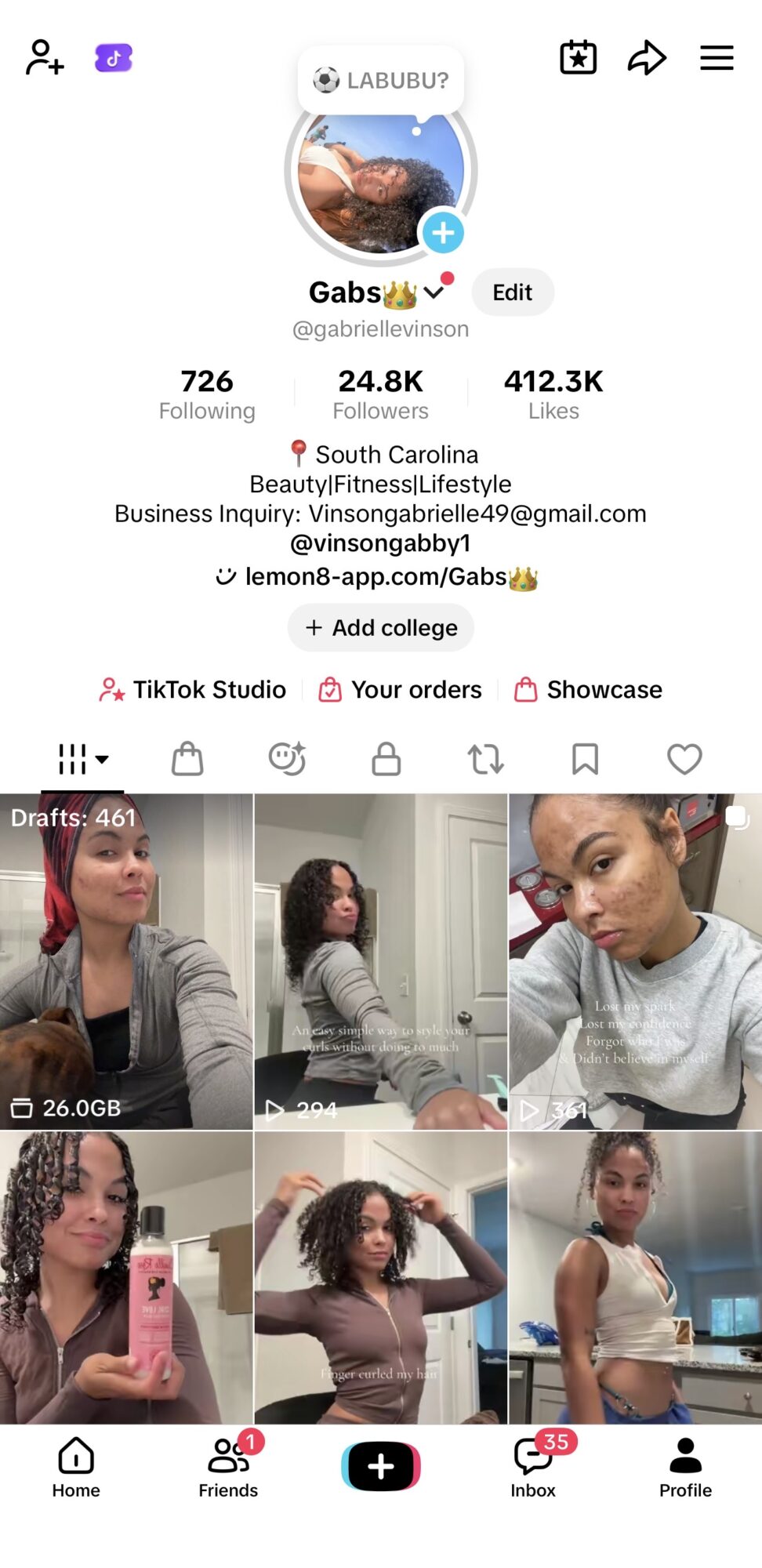 Screenshot of a social media profile page with profile picture, username, bio, and multiple video thumbnails of women.