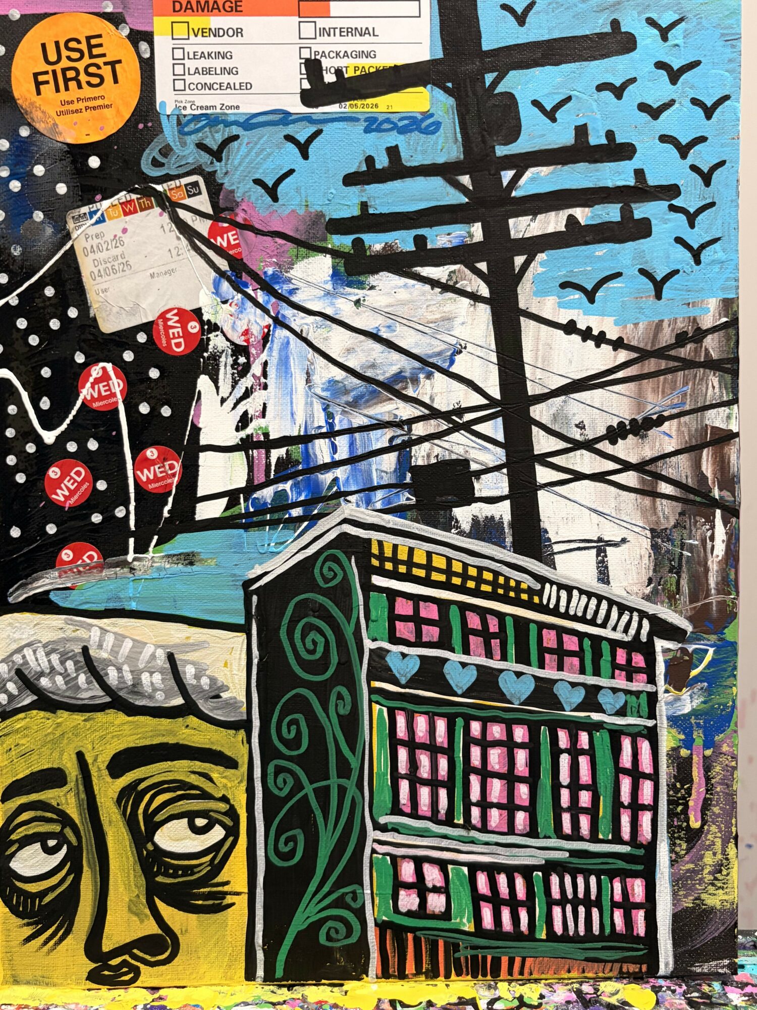 Colorful graffiti with abstract shapes, a face, and a building, featuring vibrant colors and bold lines.