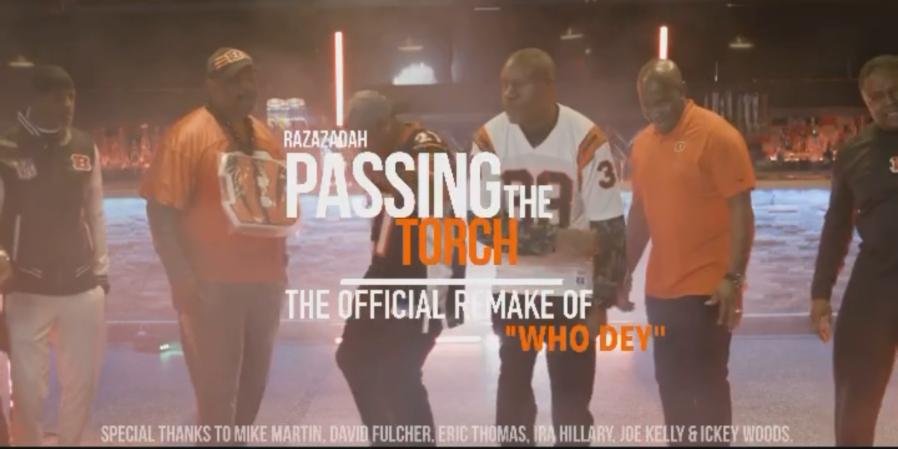 Group of people near a body of water with text overlay about passing the torch and official make of 'who dey'.