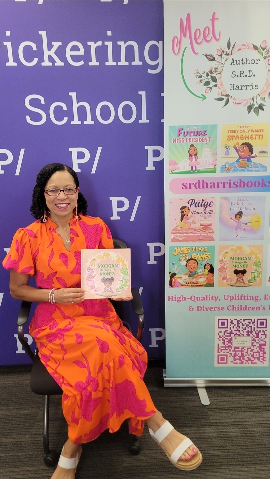 Woman in orange dress sitting on a chair holding a book, next to a colorful book display stand, background with purple text.