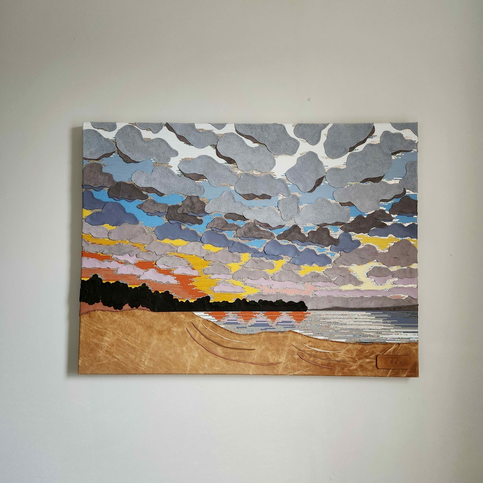 Abstract landscape painting with colorful shapes resembling a sky, land, and water, featuring various shades of blue, gray, yellow, and brown.