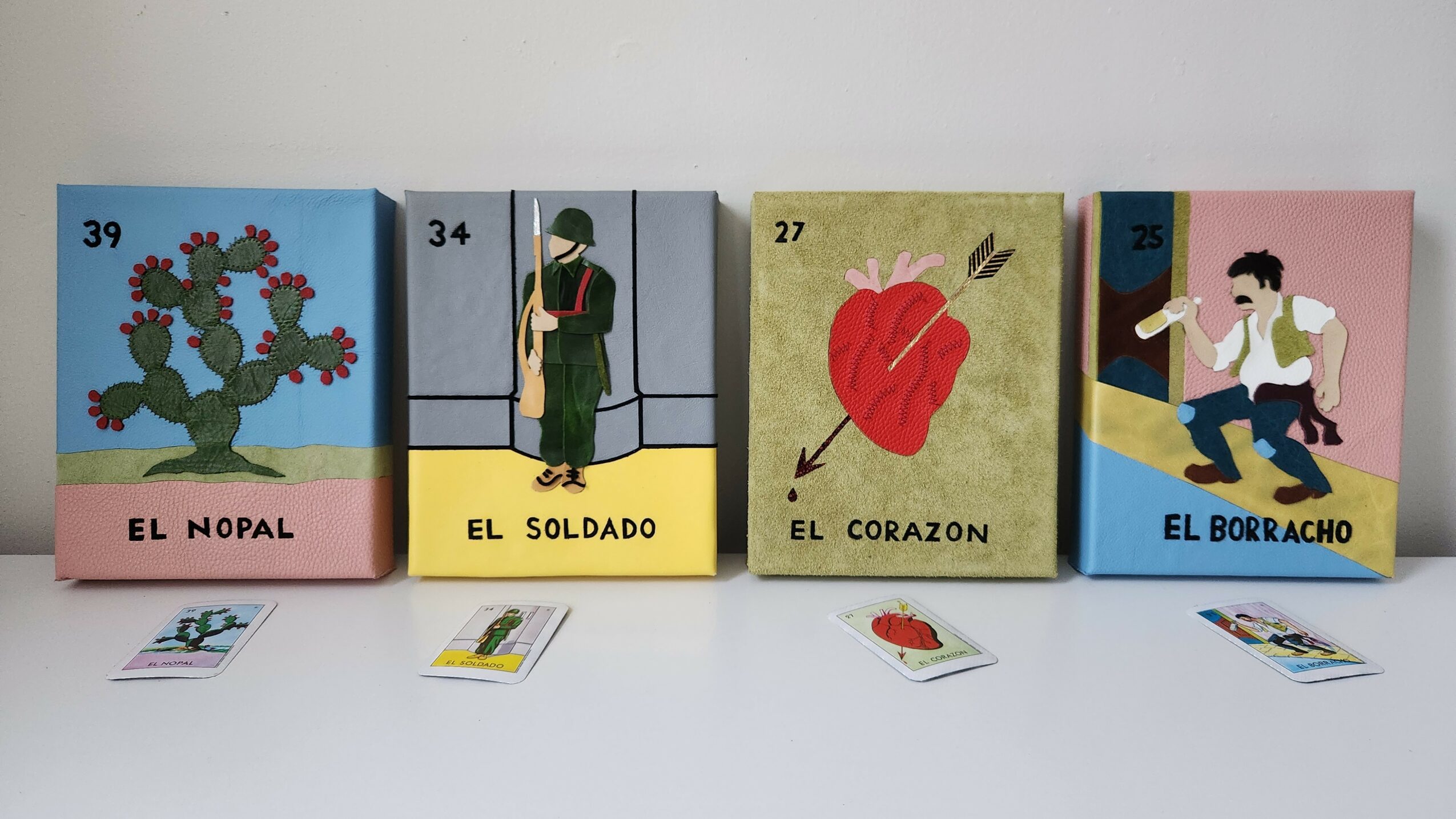 Five colorful cards with illustrations and Spanish words, numbered 39, 34, 27, 31, and 36, displayed on a white surface.
