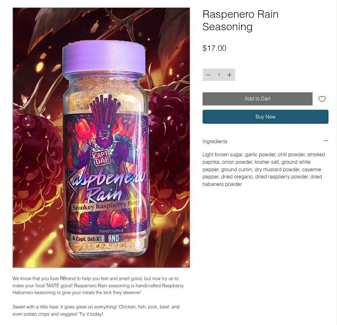 Bottle of raspberry rain seasoning with purple cap, colorful label, and background of cherries, with product details and description.