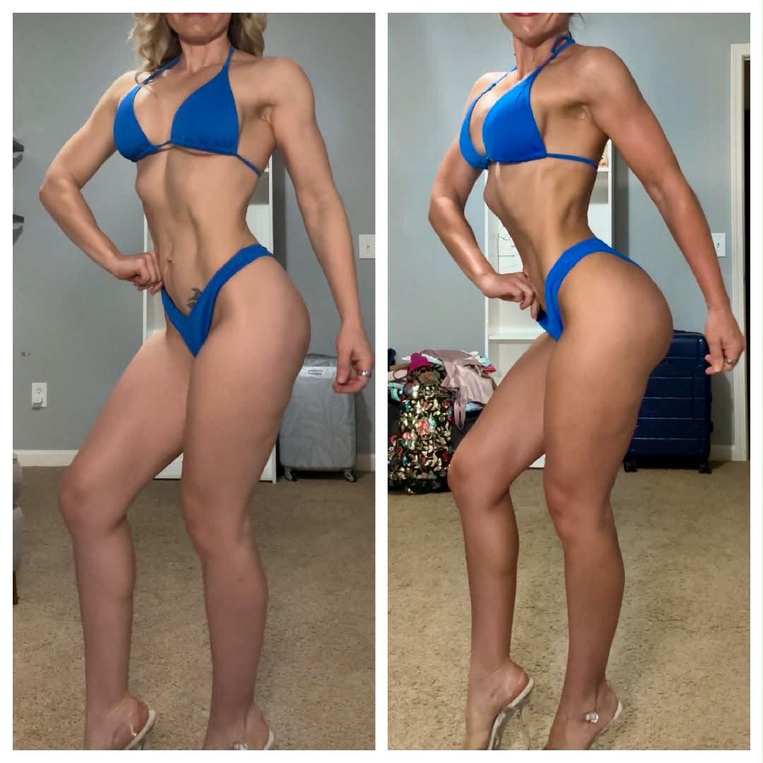 Two women in blue bikinis pose indoors, showing their side profiles with hands on hips, in front of a blue wall and furniture.