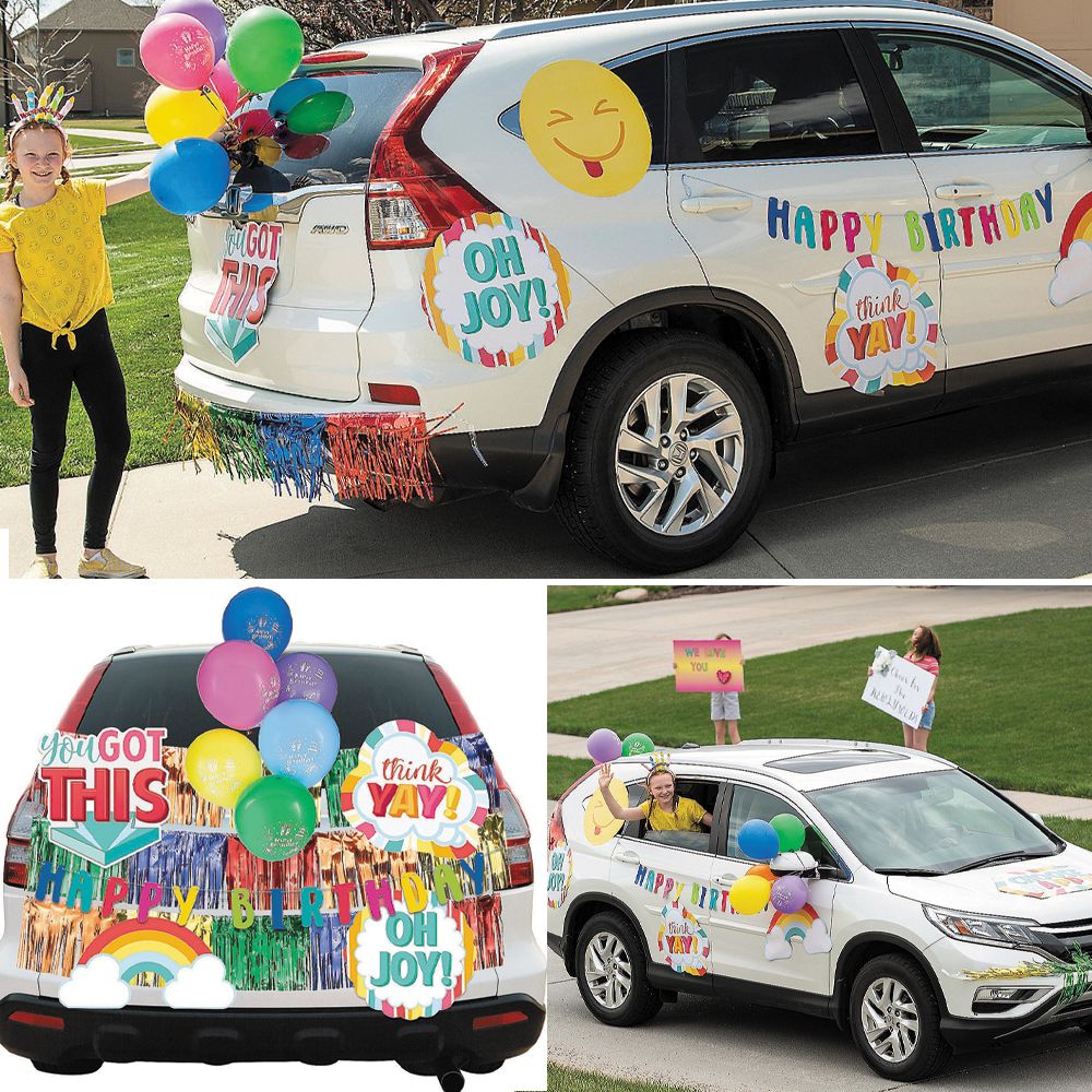 Child standing next to a decorated car with balloons, banners, and birthday signs, celebrating a birthday outdoors.