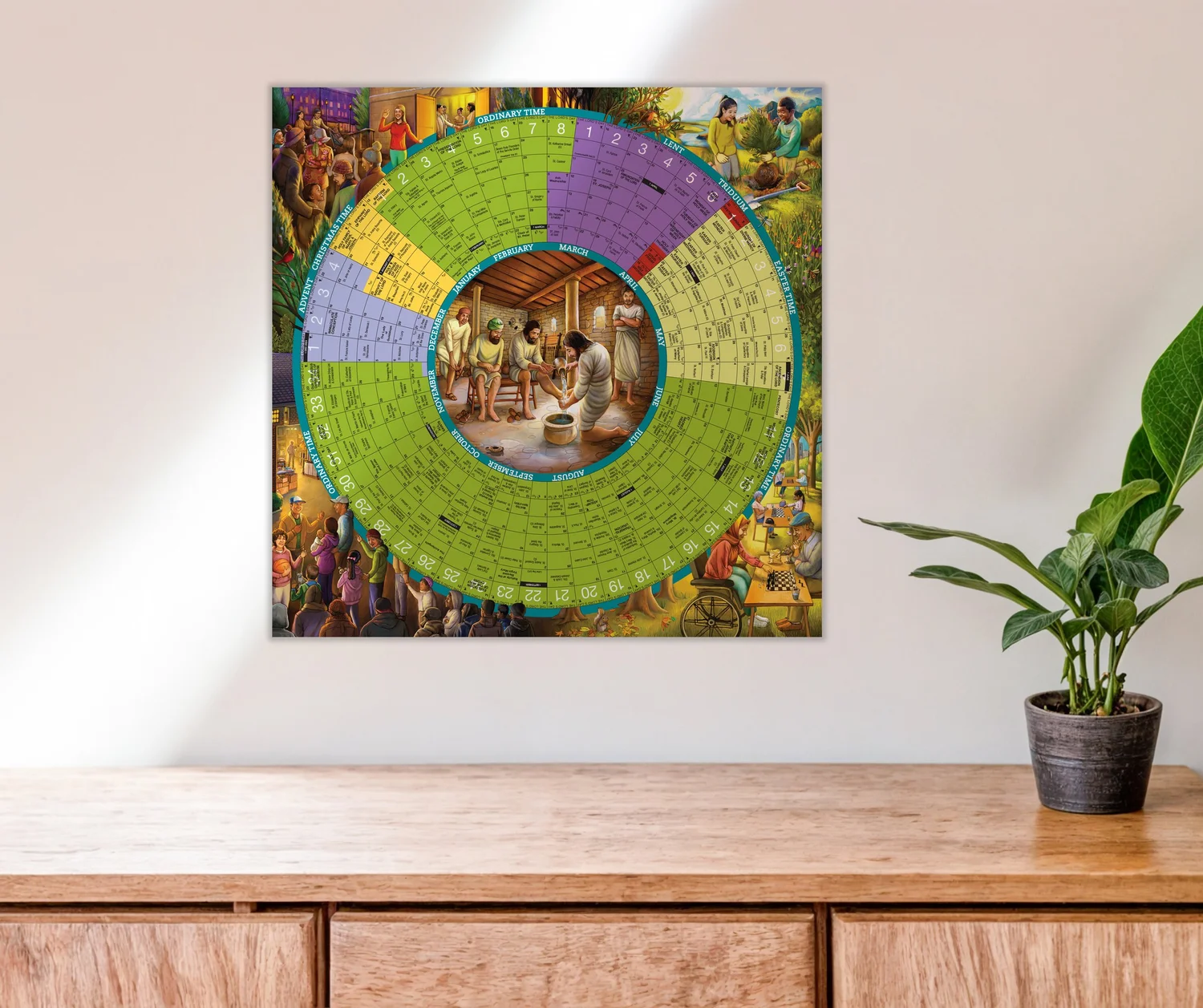Colorful circular chart with a central image, displayed on a wall above a wooden surface with a potted plant nearby.