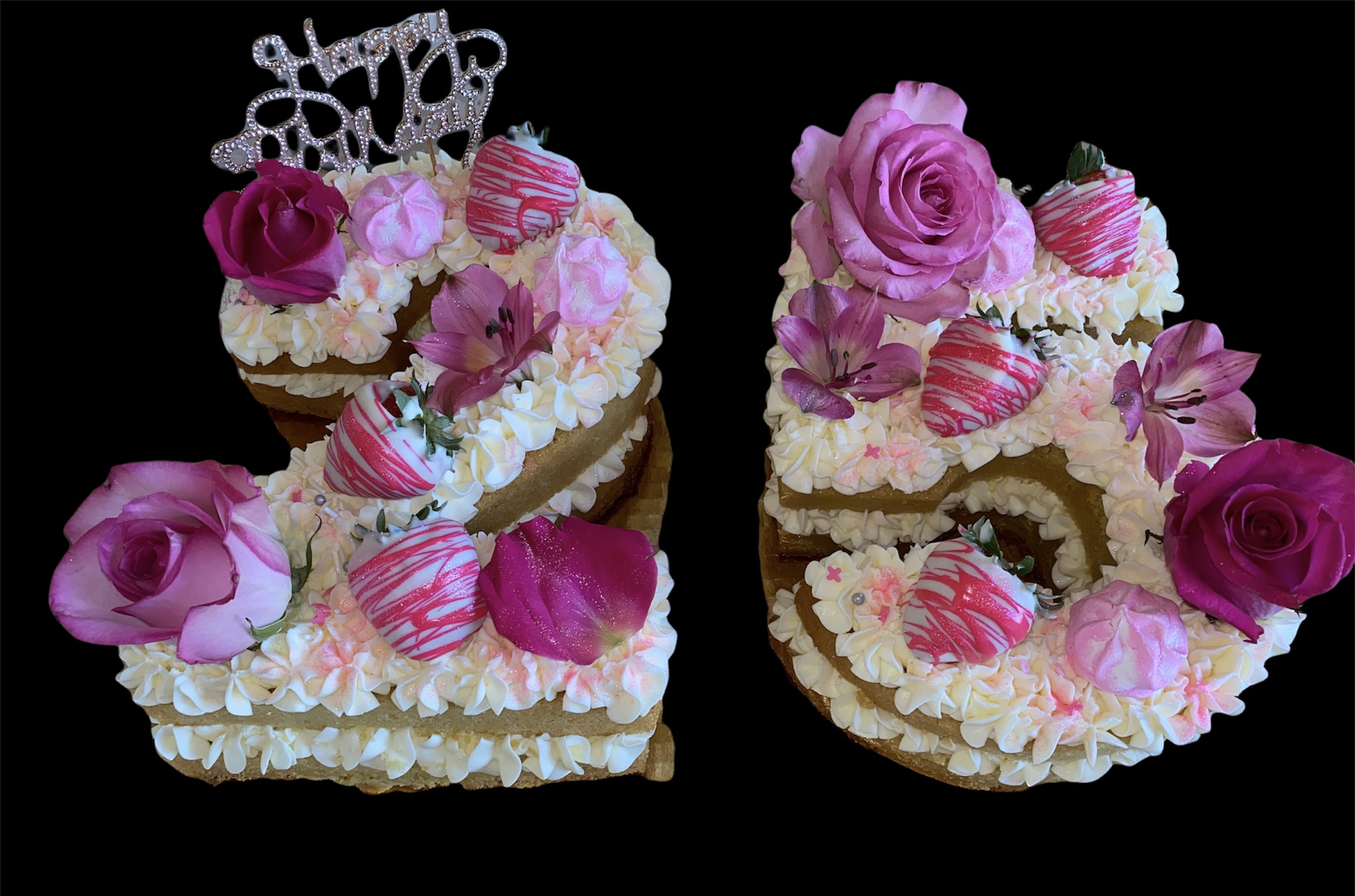 Number 20 decorated with pink roses, strawberries, and cream, with a cake topper reading 'Happy Birthday'.