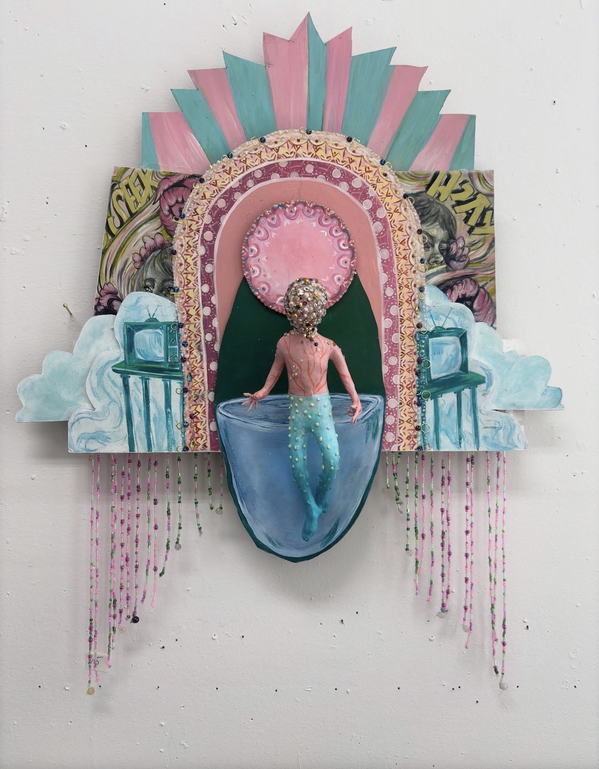 Colorful mixed-media artwork featuring a mermaid with a pink top and blue tail, surrounded by decorative elements and abstract shapes.