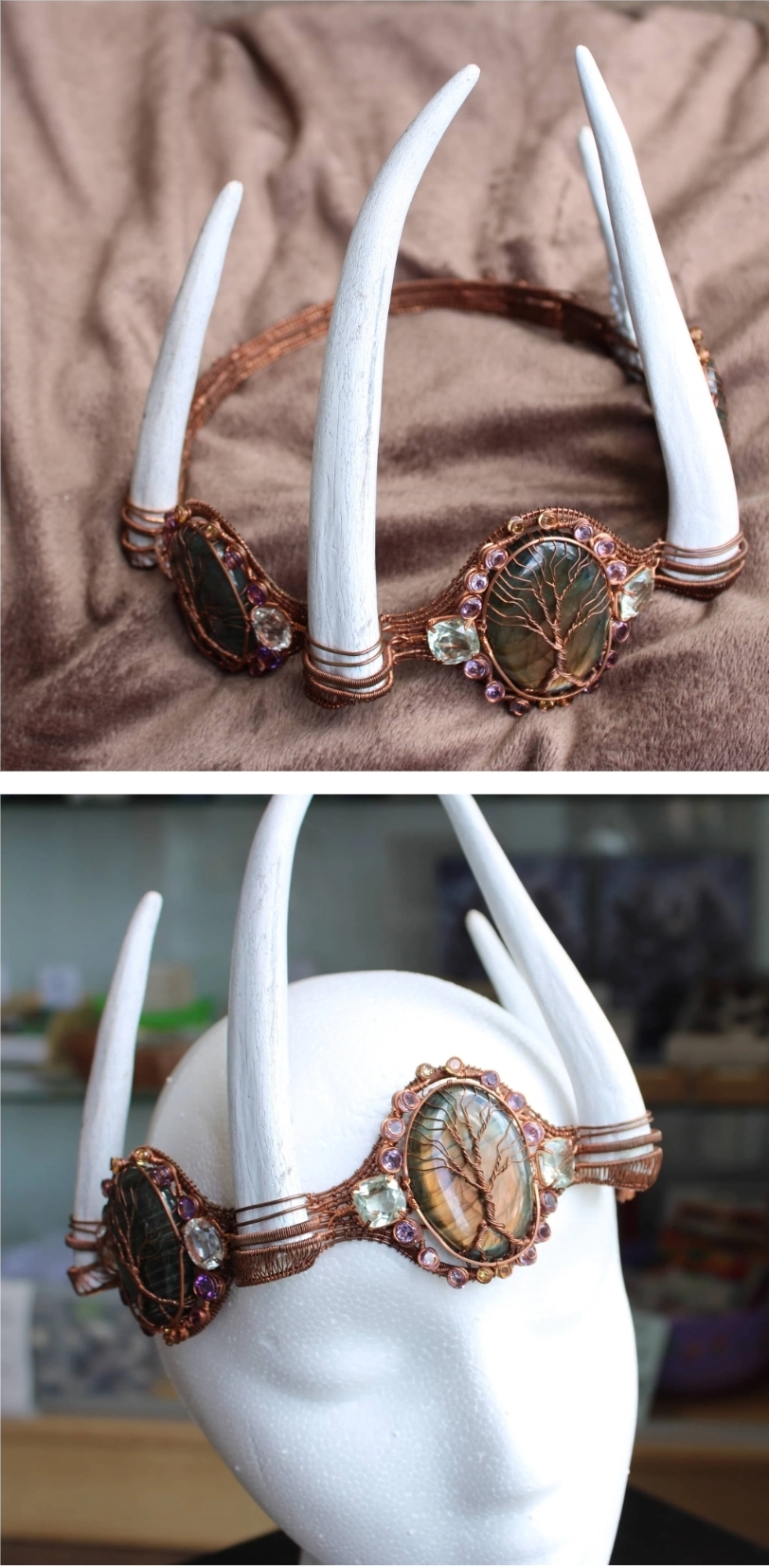 Decorative headpiece with white horns, beads, and a central oval ornament, displayed on a mannequin head and fabric background.