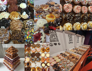 Display of various decorated donuts, cupcakes, and baked goods on tables and trays.