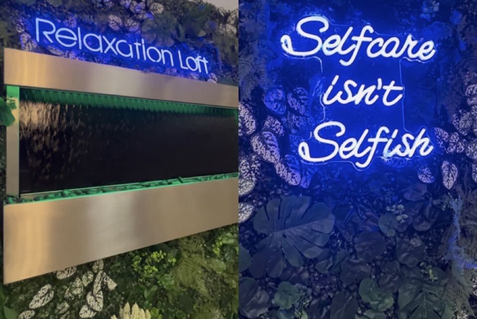 Neon sign reads 'Relaxation Loft' and 'Selfcare Isn't Selfish' on a blue background with floral patterns.
