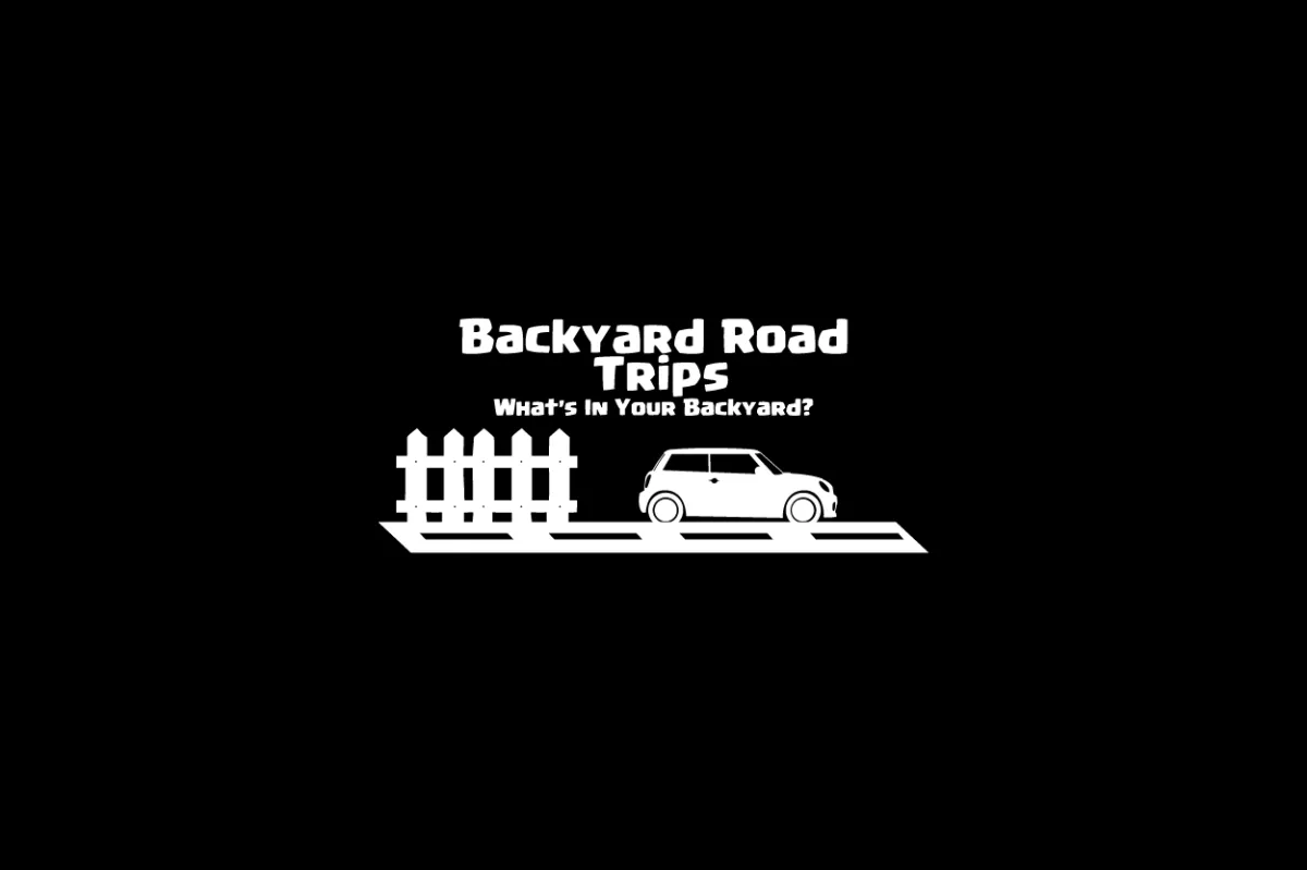 Black background with white text and a car illustration, reading 'Backyard Road Trips' and 'What's in Your Backyard?'