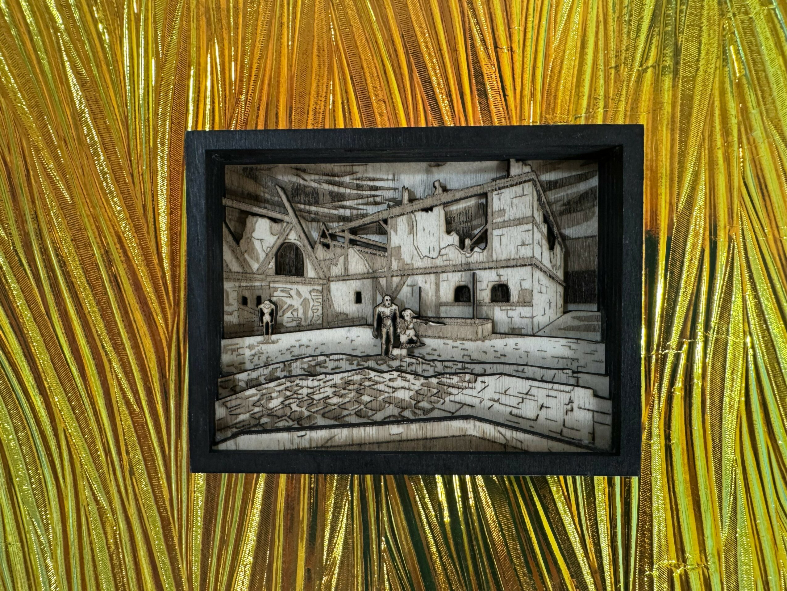 Black and white photo of a castle courtyard with people, framed and hung on a colorful, textured background.