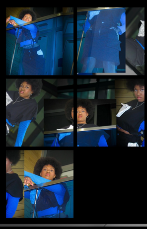 Group of young people in blue and black outfits, some looking at the camera, indoors with glass and metal surroundings.